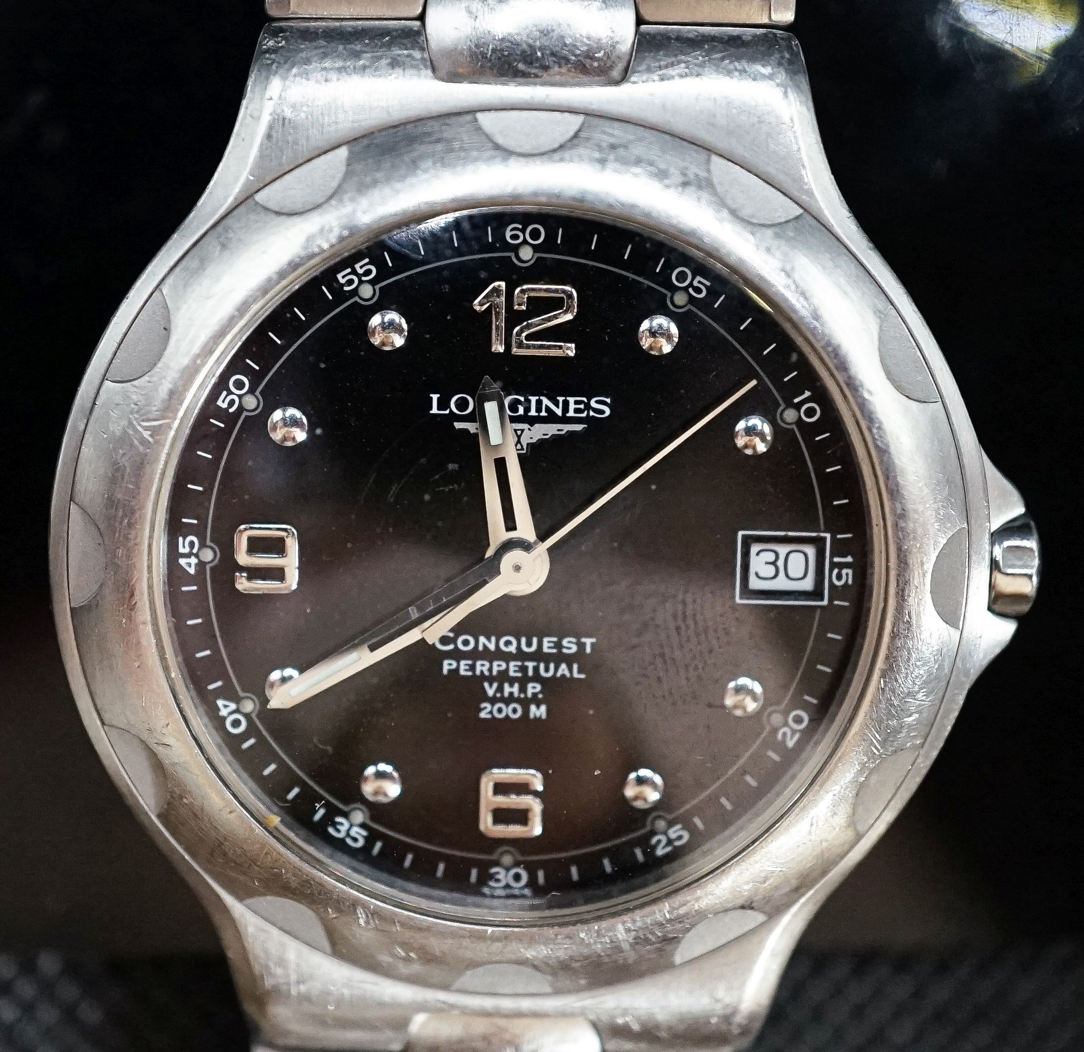 A gentleman's modern stainless steel Longines Conquest Perpetual V.H.P. wrist watch, on Longines stainless steel bracelet, case diameter 39mm.